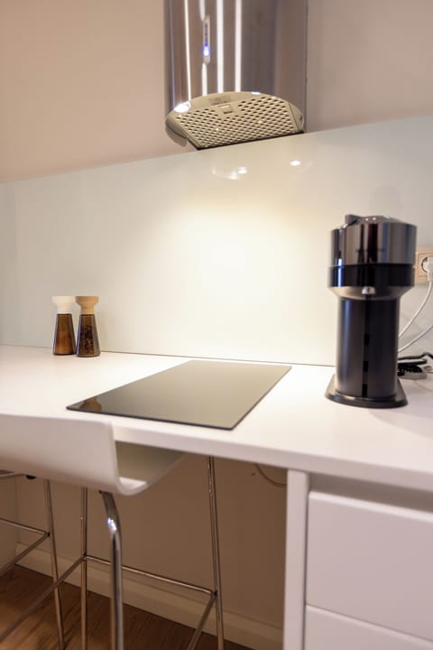 The fully equipped kitchen has all modern appliances, a GAGGENAU stove & microwave, perfect for a self-catered holiday, and a breakfast bar with two stools.