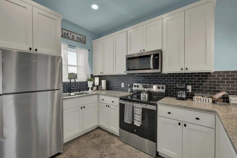 The full kitchen comes equipped with modern appliances, ample counter space, and all the essentials you need to prepare delicious meals during your stay.