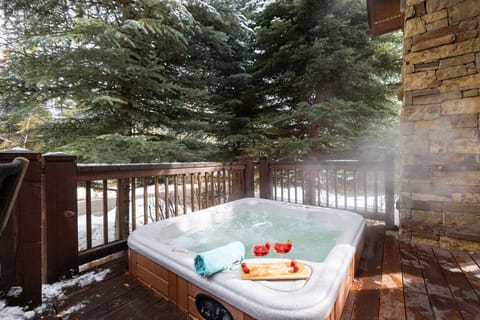 Relax in a private hot tub surrounded by nature for the perfect getaway.