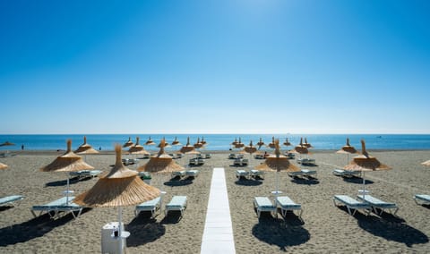 On the beach, sun loungers, beach umbrellas, beach towels