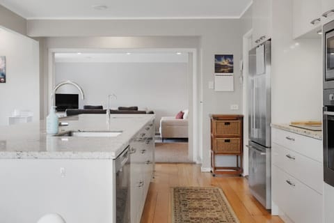 The kitchen has an oven, cooktop, microwave, dishwasher and fridge/freezer.