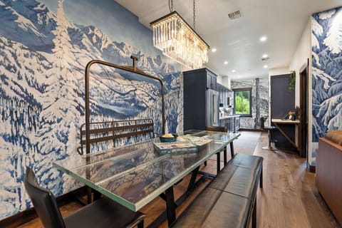 The expansive dining table offers a stunning centerpiece for memorable meals and gatherings.