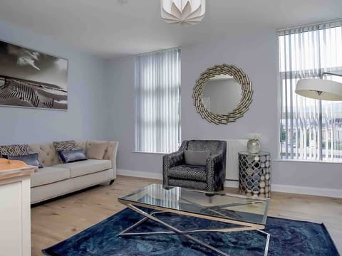 Spacious living area where all the guests can relax together. A relaxing space furnished with comfortable but stylish pieces accompanied by a smart tv, perfect for some down time together.
