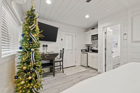 Nearby kitchenette, dining nook, and elegant holiday touches.