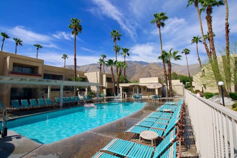 Relax by the sparkling outdoor pool surrounded by palm trees and stunning mountain views, located just minutes from the Palm Springs Aerial Tramway in this spacious two-bedroom condo complex.