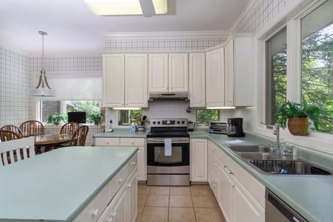 Kitchen with drip-style coffee pot, breakfast nook for 6, and island seating for 2