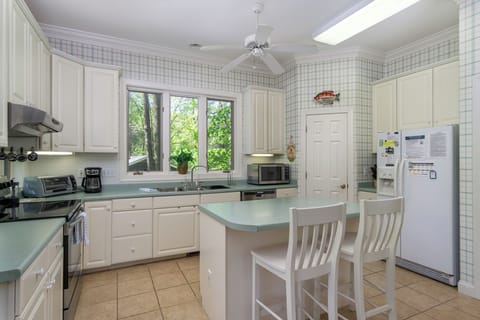 Kitchen with drip-style coffee pot, breakfast nook for 6, and island seating for 2