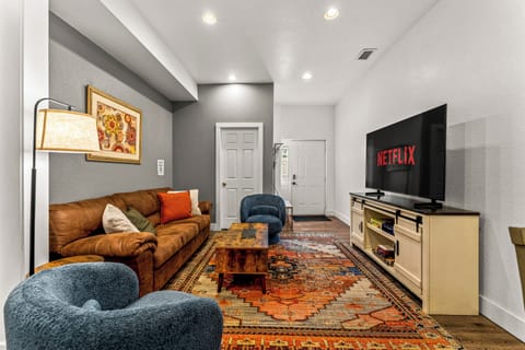 The restful living space holds a large sectional, charming decor and Smart TV with Netflix.