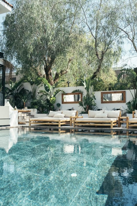 Outdoor pool, open 9:00 AM to 7:00 PM, pool umbrellas