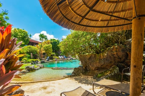 Relax by the pool on a lounger in the shade