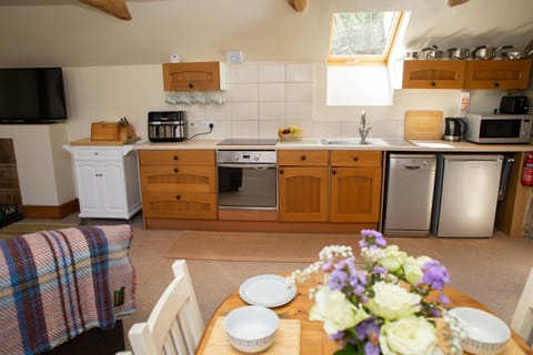Kitchen area with microwave, dishwasher, and electric oven