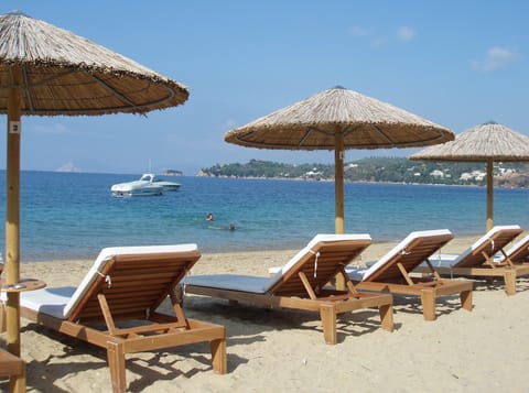 On the beach, white sand, sun loungers, beach umbrellas