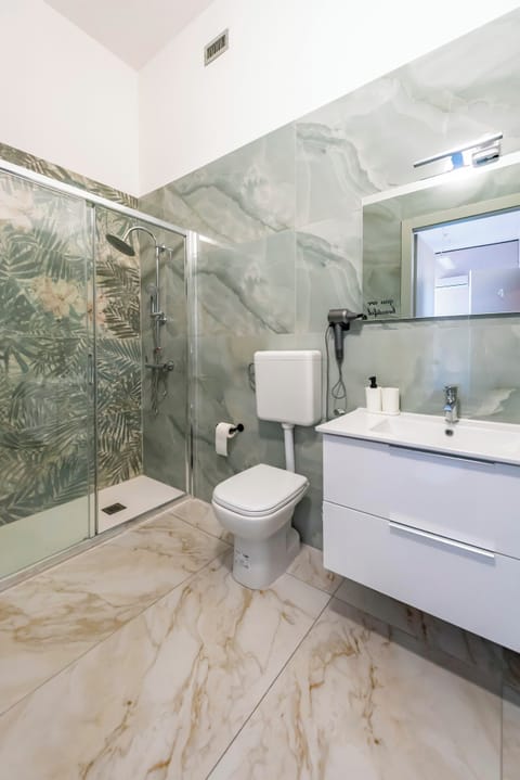 Shower, hair dryer, towels, toilet paper