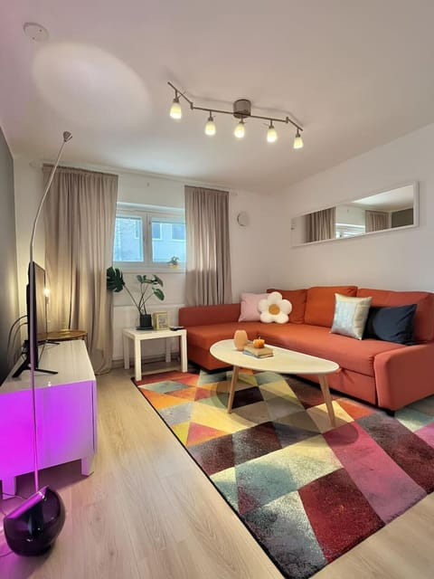 Set the mood with the Philips Hue Iris ambiance Smart Lamp, casting a soft, relaxing glow in the living room.