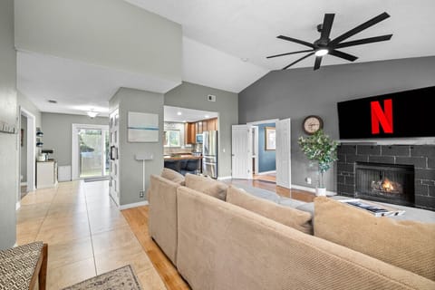 Bright and airy layout with smart TV, fireplace, and easy access to the backyard and kitchen.
