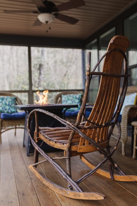[Porch] Guest favorite Amish rock chair by the firetable. 