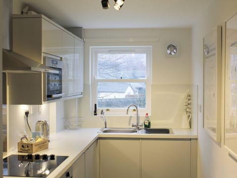 Well-equipped fitted kitchen | 12A Elm Court - Greta Grove Apartments, Keswick