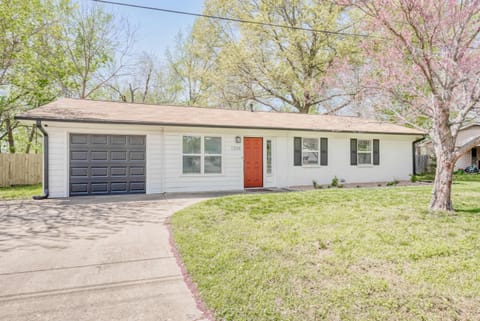 Charming curb appeal with crisp white siding, a cheerful orange door and mature trees—your Bentonville base camp awaits.