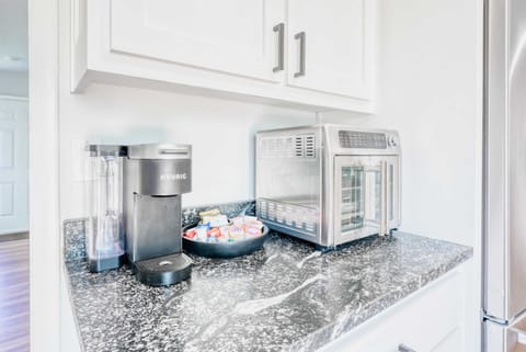 Coffee bar with Keurig & toaster oven ensures effortless mornings and late-night snacks.