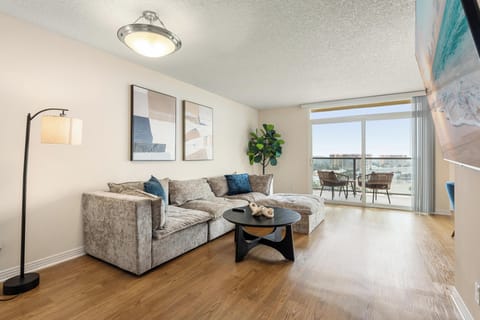 Living Room with Balcony Access -  Cozy up on the plush sofa with views