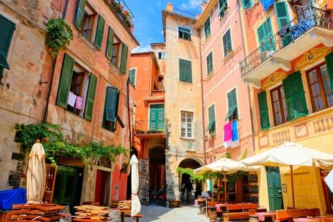 Colorful square with restaurant tables in the village of Monterosso