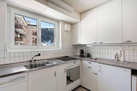 Fully Equipped Kitchen with Alpine Views Cook up your favorites in the functional kitchen, complete with a stove, oven, dishwasher, and mountain-view window.