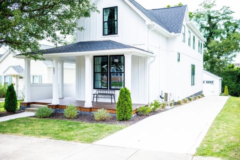 Modern farmhouse exterior with front porch and plenty of parking. 