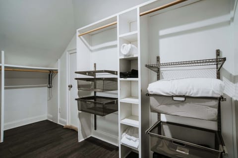 Plenty of room to unpack and feel at home — this spacious walk-in closet offers organized shelving, extra linens for game room bed, and thoughtful touches to keep your stay clutter-free and comfortable.