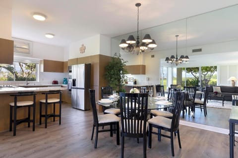 Entertain effortlessly in a bright, spacious kitchen and mirrored dining area with modern flair.