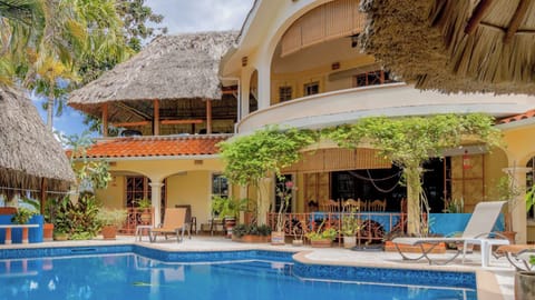 Spacious villa with shaded terrace, perfect for outdoor living and dining.