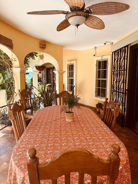 Covered outdoor dining area with seating for family and friends.