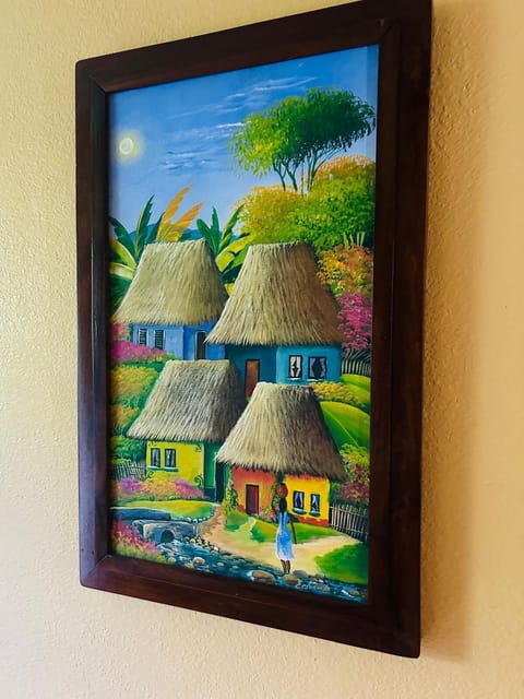 Vibrant Belizean artwork featuring traditional thatched homes.