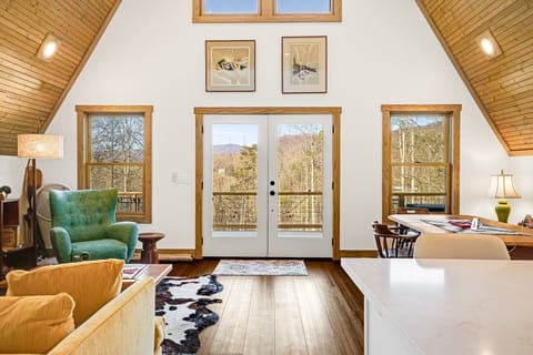 Living/dining great room with view out to the deck
