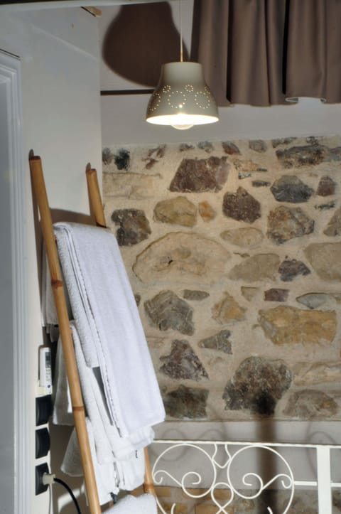 Charming Stone Accent Wall in Bedroom – Natural stone feature adds timeless elegance.
