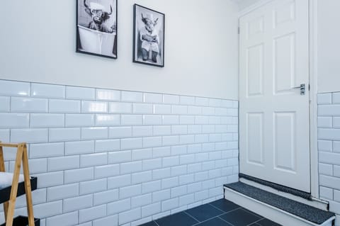 The spacious family bathroom is equipped with a bath and overhead shower, a WC and toilet.