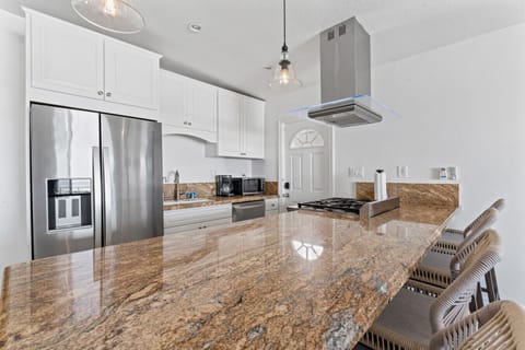 Elegant kitchen with a stunning granite countertop and modern appliances.