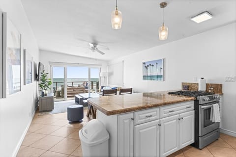 Open-concept kitchen with a spacious island and ocean views.