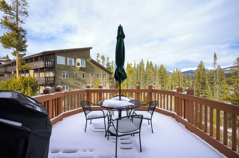 - Snow covered deck with mountain views creates a perfect outdoor retreat - Patio table and chairs invite you to relax and take in the alpine setting - Scenic forest surroundings enhance this peaceful winter getaway spot
