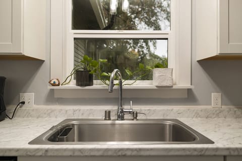 Kitchen window overlooking the peaceful backyard