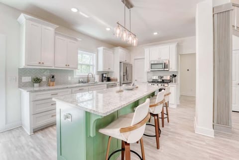 A sun-drenched kitchen, perfect for culinary adventures. Modern elegance meets coastal charm.