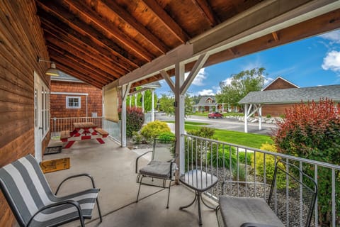 Outside patio with lounge furniture, BBQ, seating, and a sun shade!