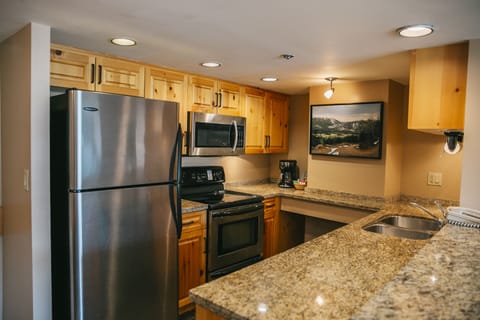 Suite 407, Two Bedroom, Gold | Private kitchen | Full-size fridge, microwave, stovetop, coffee/tea maker