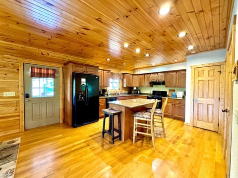 Kitchen: Experience culinary delights in this spacious wood-paneled kitchen with modern amenities!