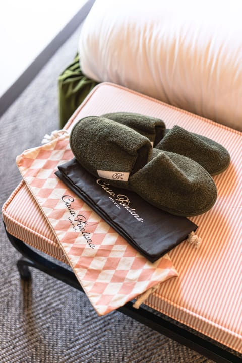 Designer toiletries, hair dryer, slippers, towels