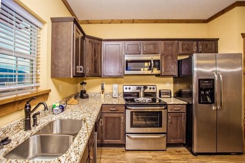 This modern kitchen showcases sleek stainless steel appliances and elegant granite countertops, perfect for culinary enthusiasts seeking convenience and style.