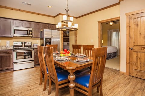 Enjoy the inviting dining area with modern amenities, featuring a stylish table set under a chic chandelier, perfect for family gatherings in the heart of the Villas of Sedona.