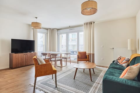 Spacious living area featuring comfortable decor, elegant seating, and access to the balcony—ideal for quality time with friends or family.