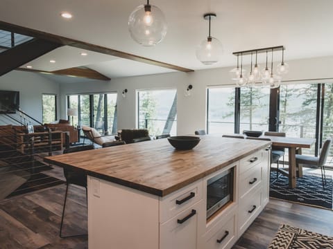 The modern kitchen offers an oversized island with additional seating for four guests | Main Level