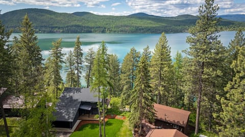 Perched above Whitefish Lake, this home offers incredible lake and mountain views | Exterior