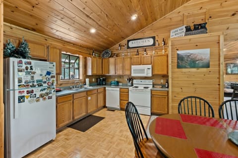 Prepare your favorite meals in this fully equipped kitchen, where warm wood cabinetry, cheerful décor, and all the essentials make you feel right at home.
